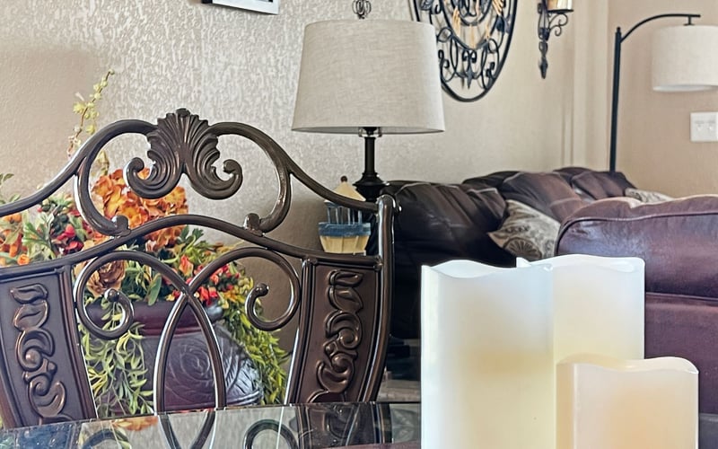 A living room with a couch and a table with candles on it